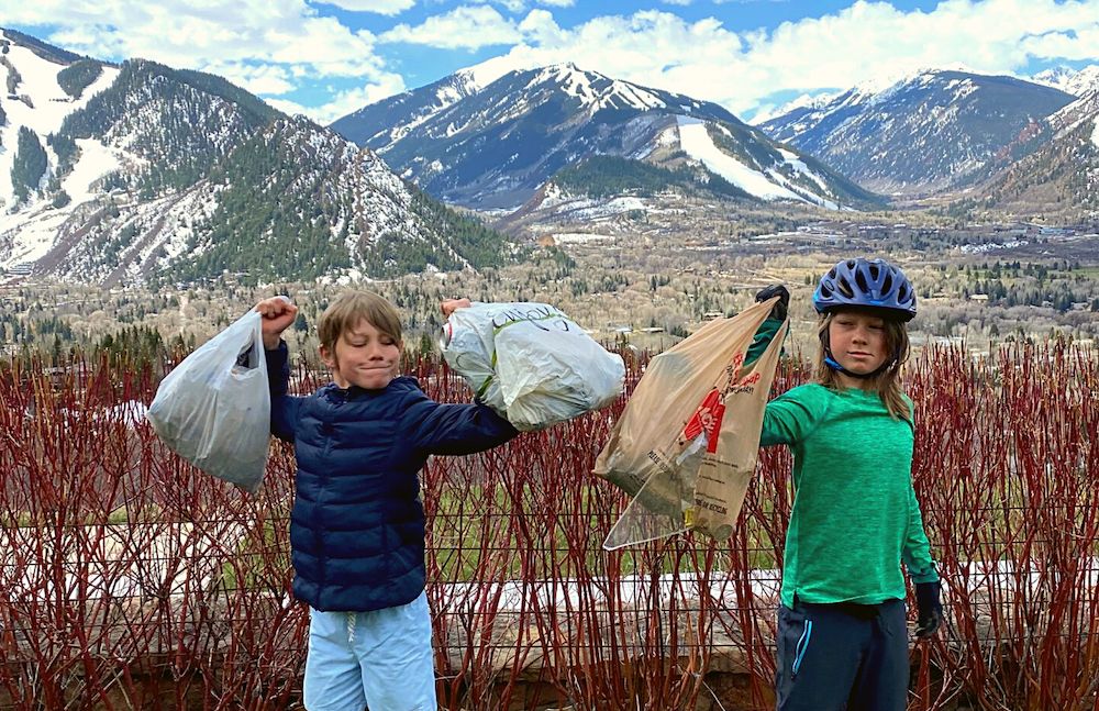 boys picking up trash on Earth Day