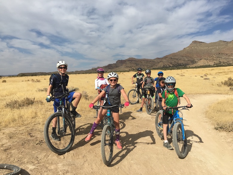 Fifth Graders with their bikes on a dusty trail