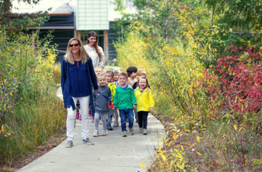 PreKindergarten students walking on path with teachers