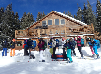 group of skiers outside Sangree Froelicher hut of TMTA