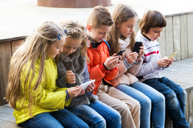 children looking at their phones